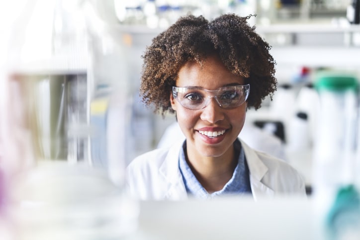 Close-up portrait of young scientist smiling.