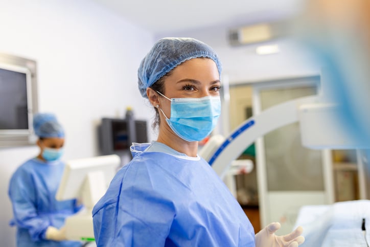 Female surgeon with surgical mask at operating room.